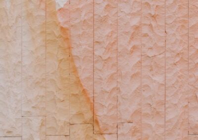 Textured stone wall with orange and white streaks